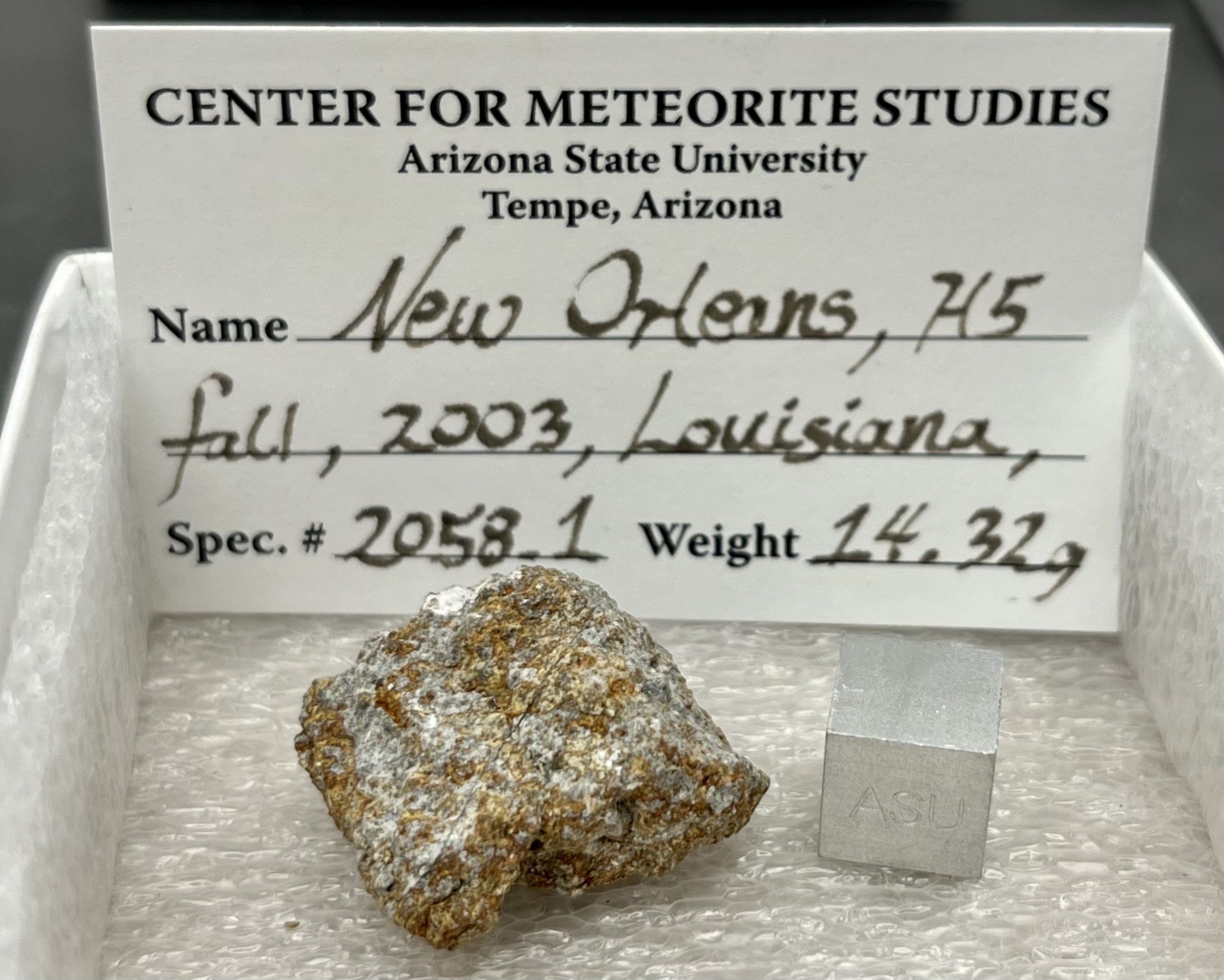 Interior fragment of New Orleans meteorite with 1cm scale cube.