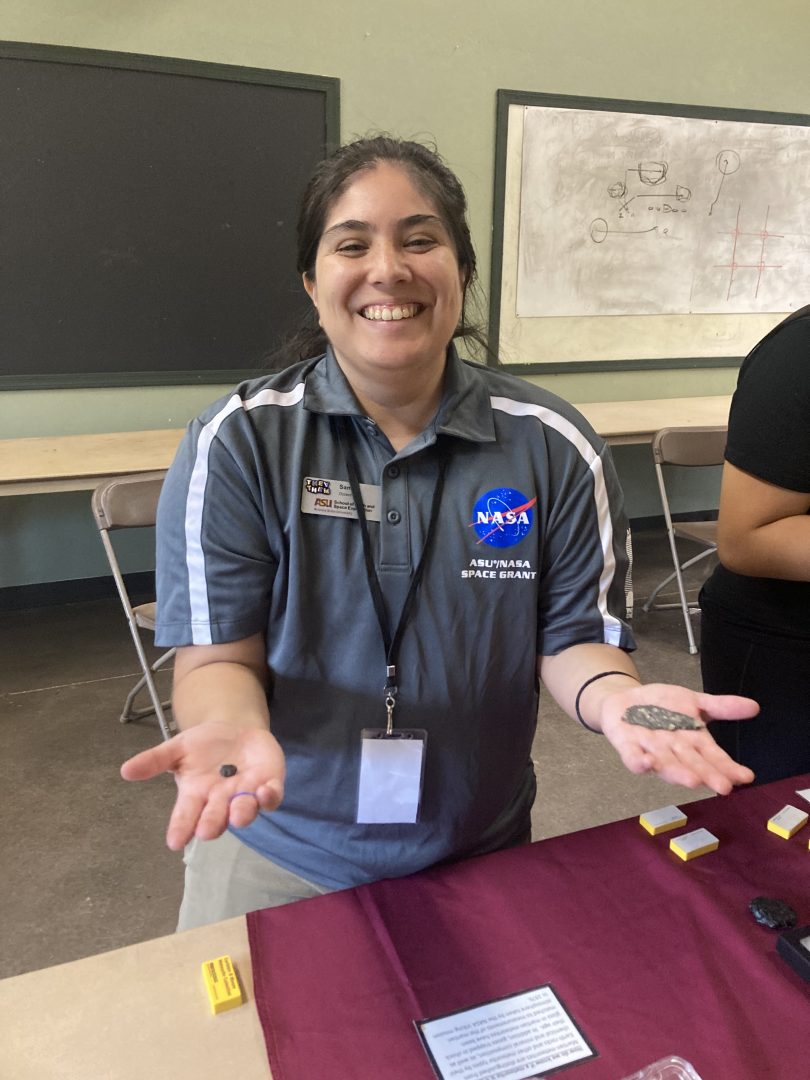 Sam Campbell holds lunar and martian meteorites at Camp SESE 2023